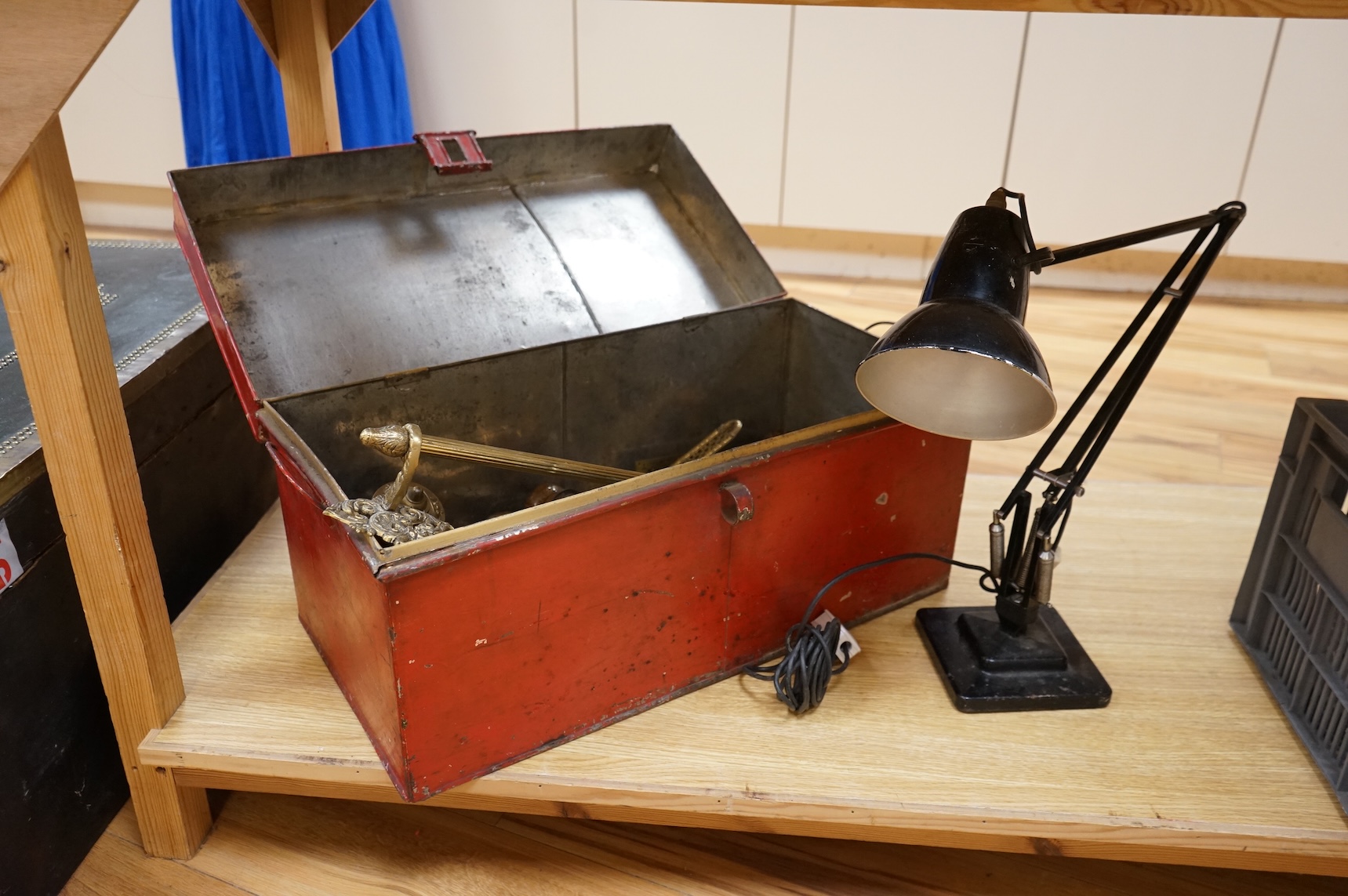 An Anglepoise lamp and metal door furniture and fittings in a tin trunk